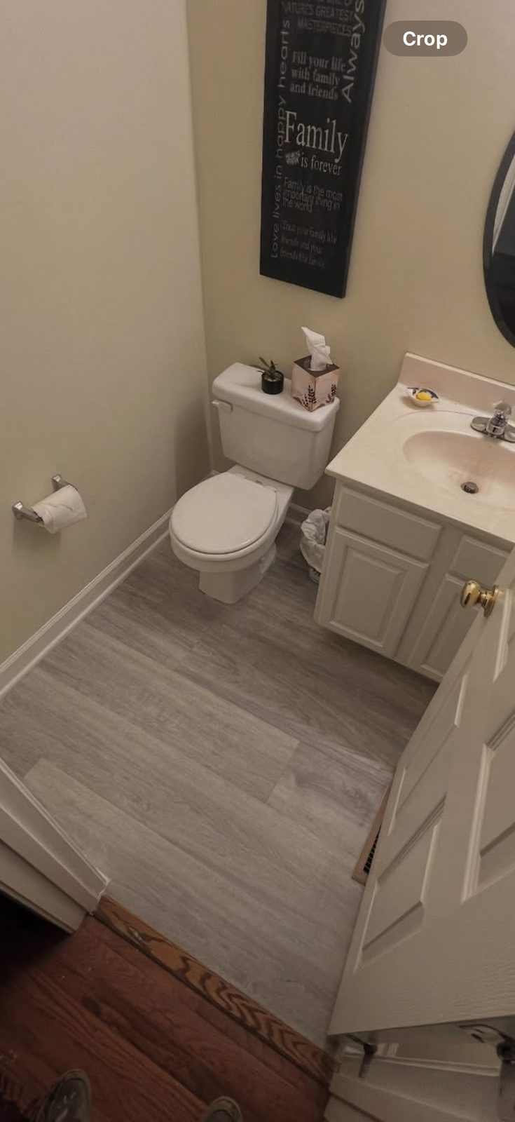 Bathroom floor after renovation, new gray plank flooring