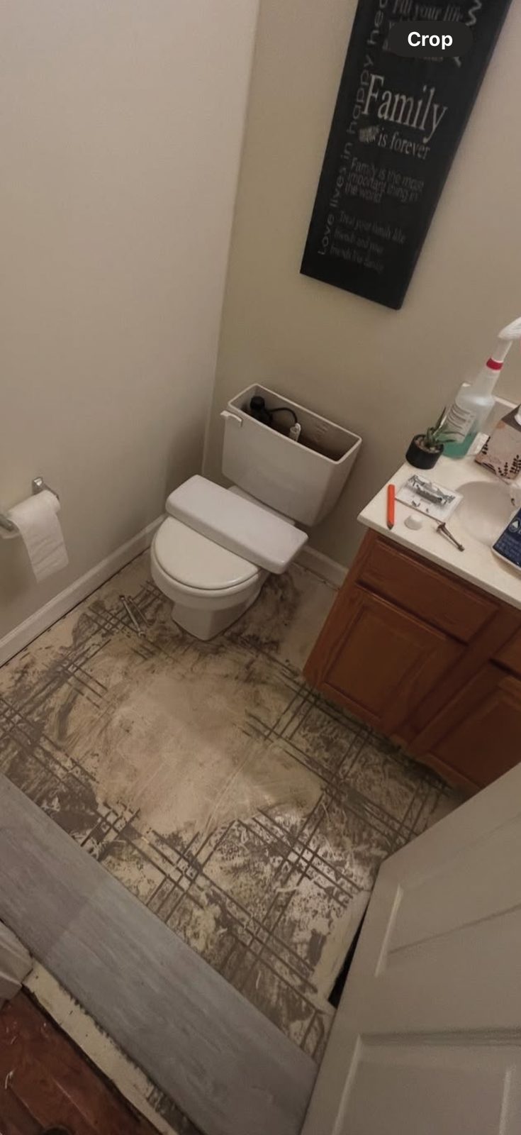 Bathroom floor before renovation, damaged subfloor