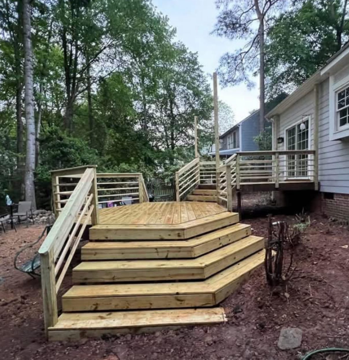 Newly built multi-level wood deck with stairs and railing